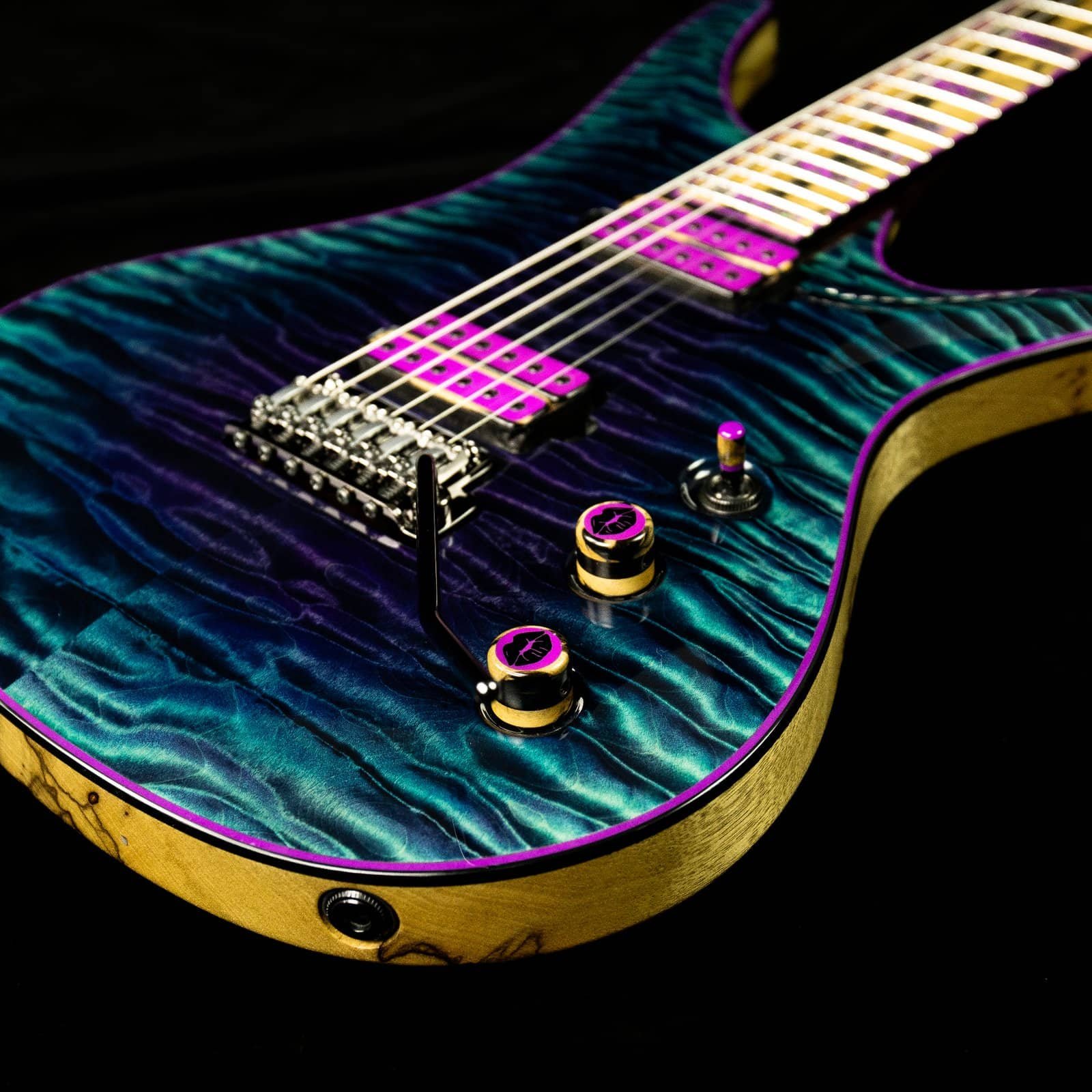 ViK Duality with a teal quilted maple top, magenta pickup covers, and spalted maple binding